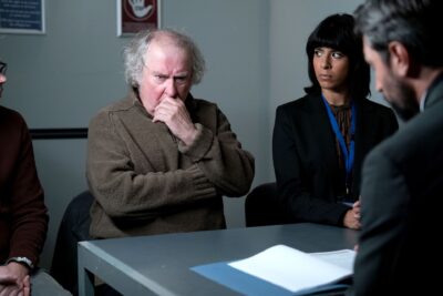 Nigel looks confused as he sits in the police station in EastEnders