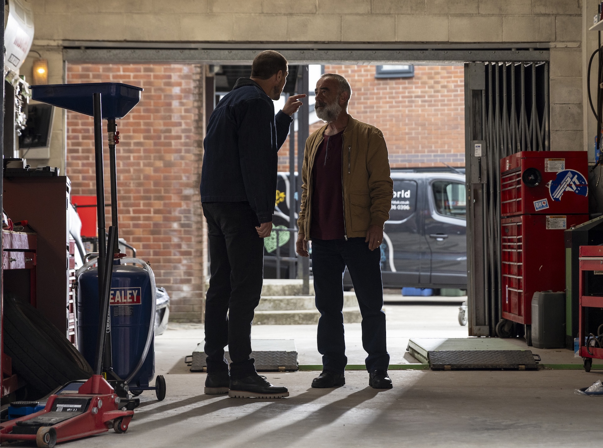 Carl and Kevin arguing at the garage in Coronation Street