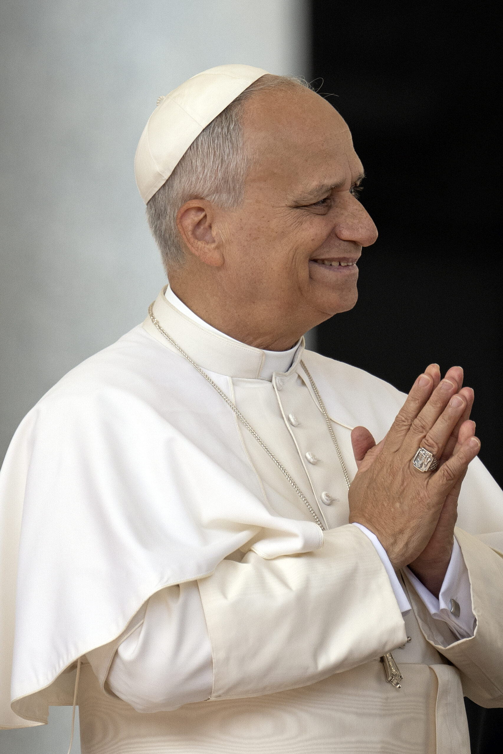Pope Leo clasping his hands together