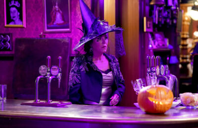 Kat looks worried while wearing a witch's hat