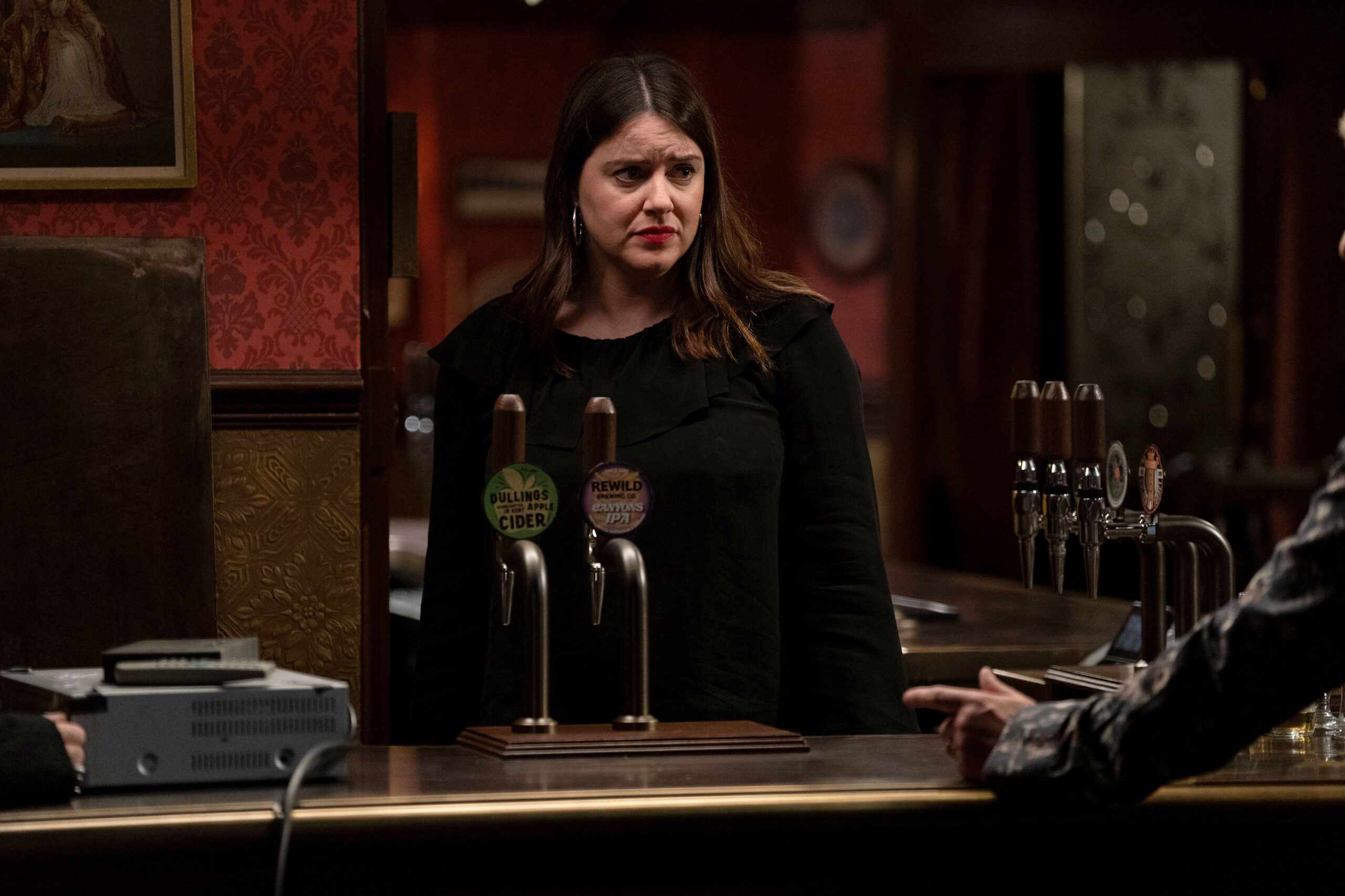 Zoe looks worried in EastEnders