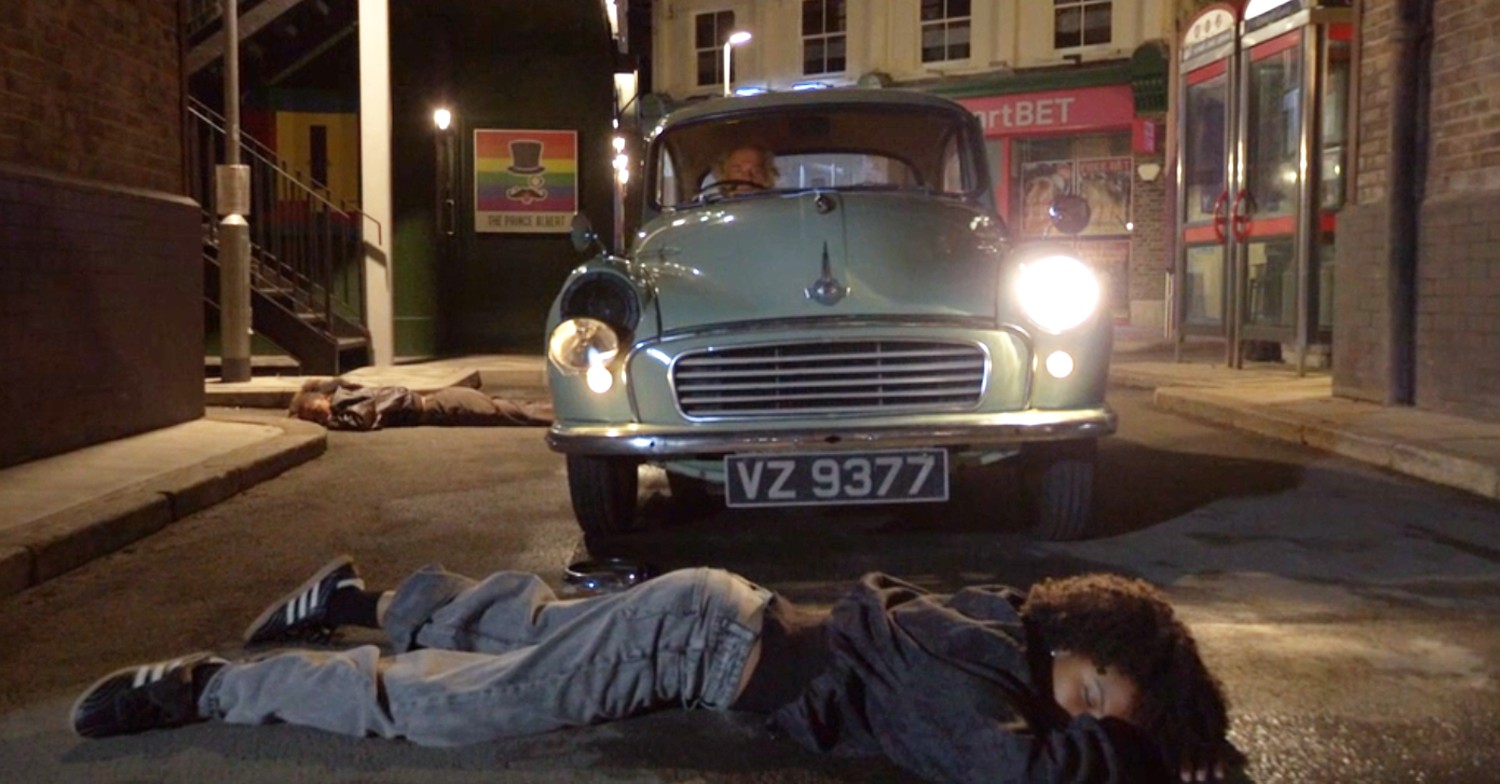 Gina lies unconscious after Nigel's car crash in EastEnders