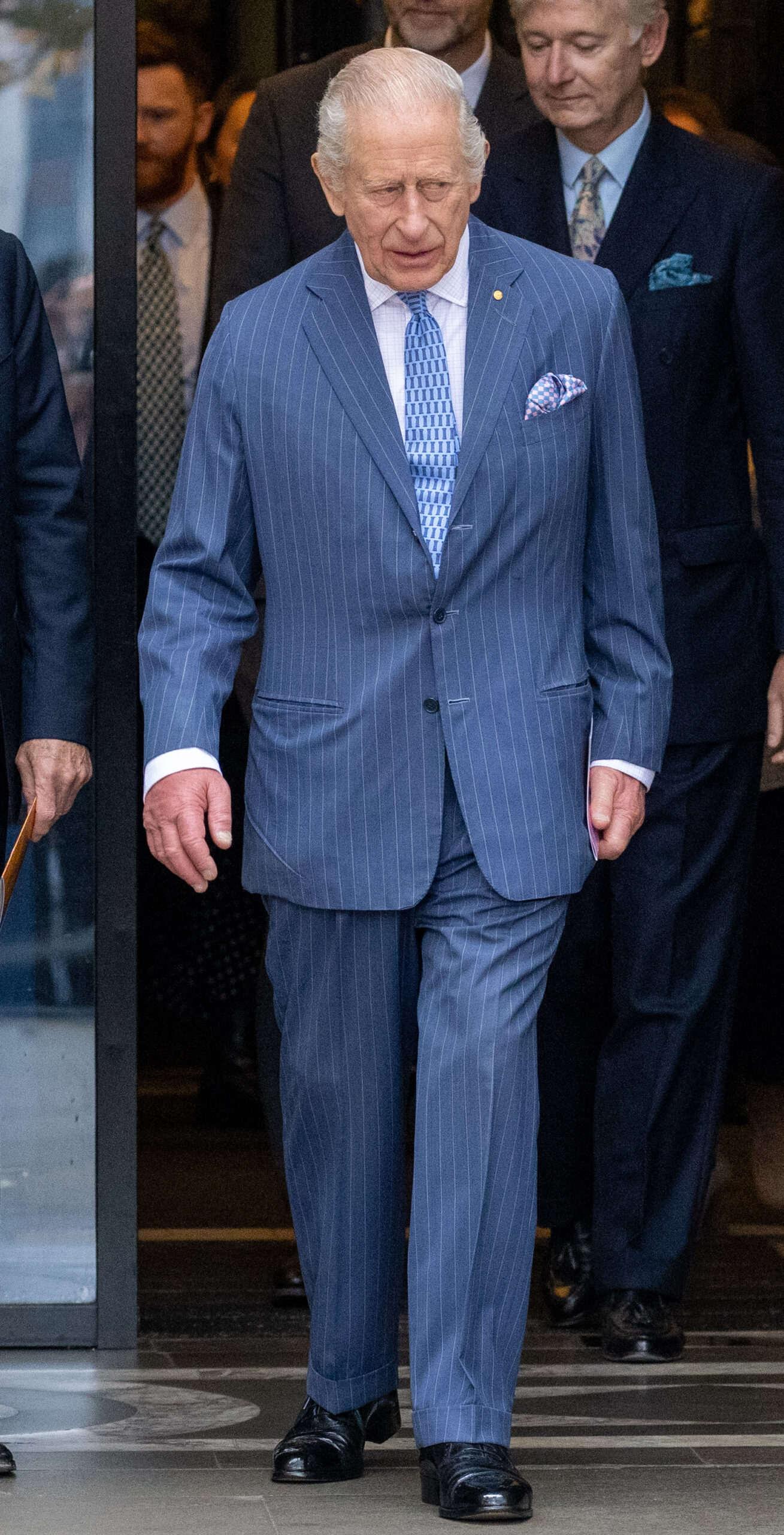 King Charles walking in blue suit