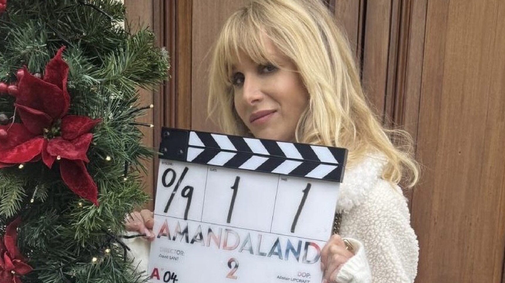 Lucy Punch with clapperboard for Amandaland Christmas Special