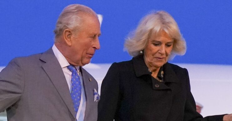 King charles speaking to Queen Camilla as they leave plane