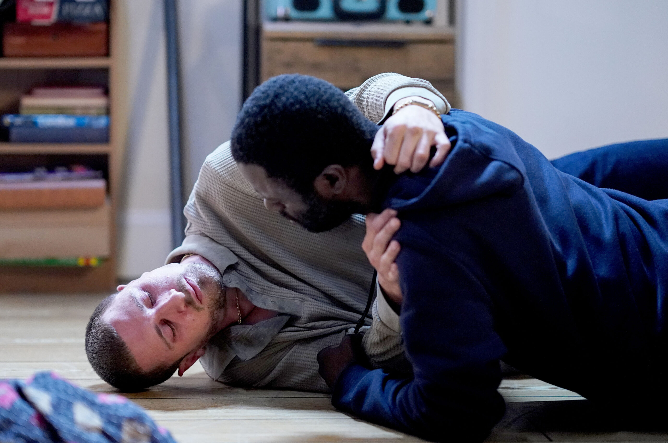 Kojo tries to help Harry, who's drugged-up on the floor
