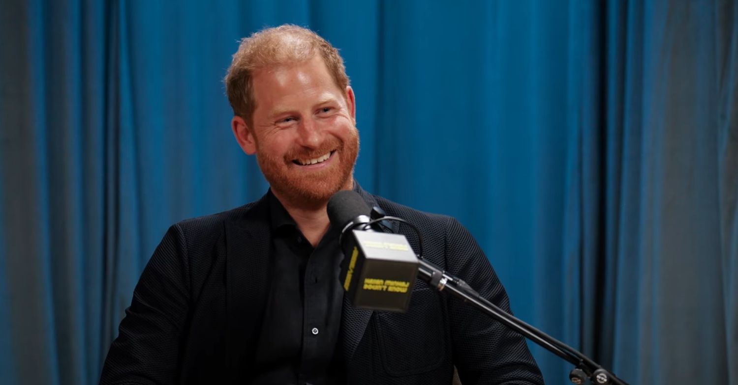 Prince Harry in a black suit on Hasan Minhaj's podcast