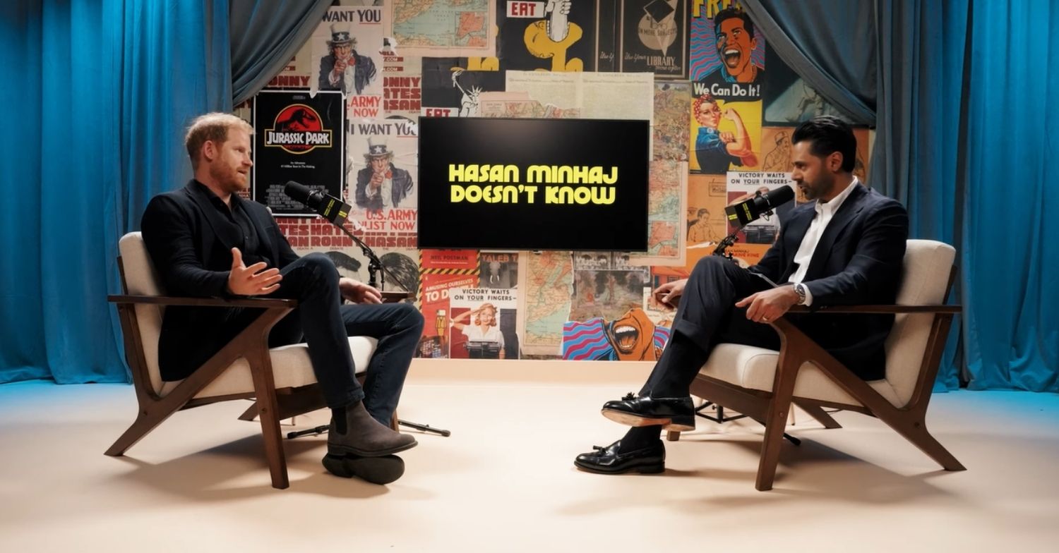 Prince Harry in a black suit on Hasan Minhaj's podcast