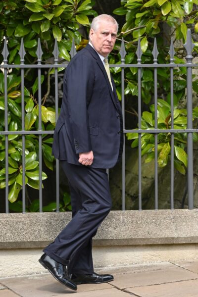 Prince Andrew walking out in public looking at camera