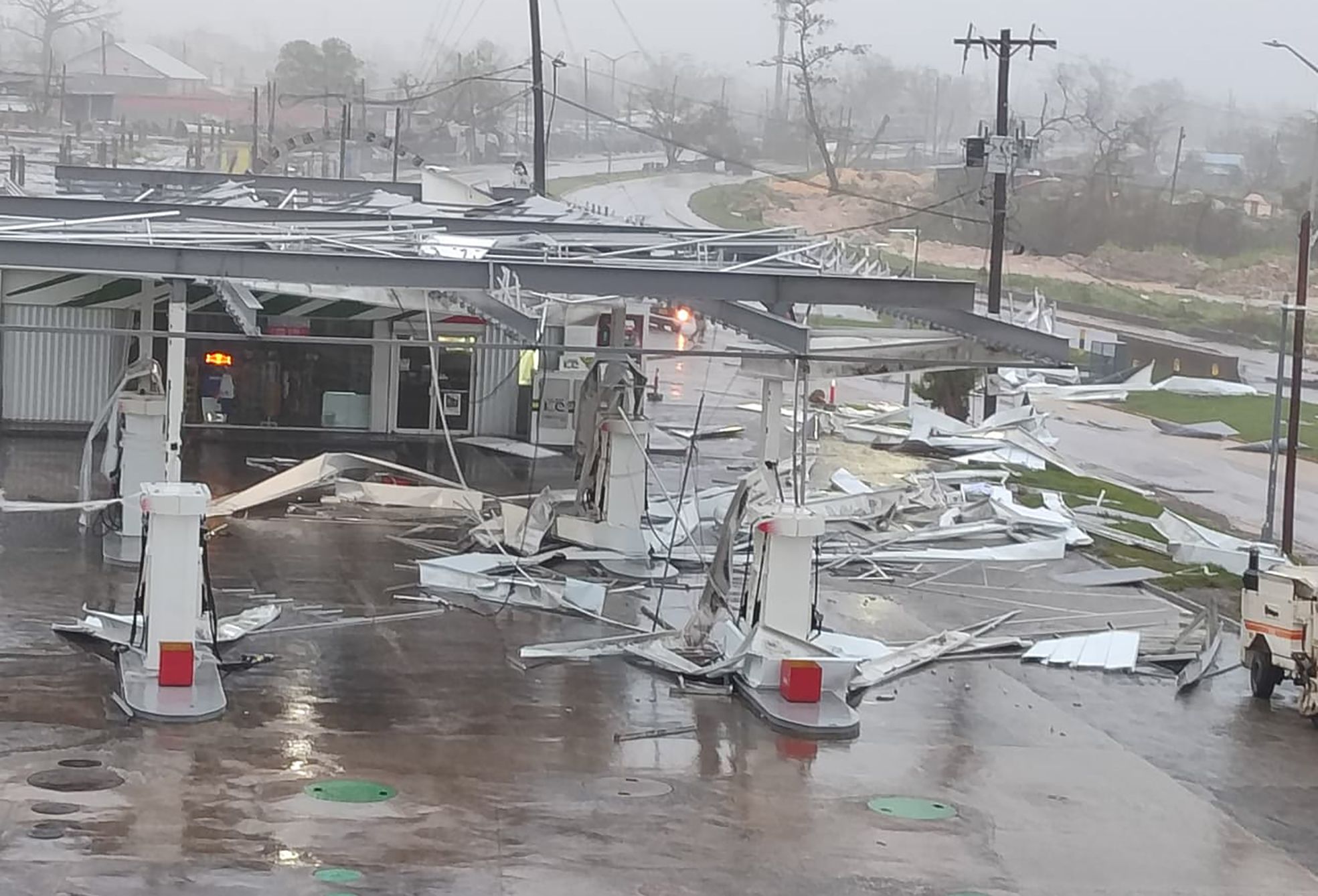 The image shows a gas station damaged by the Hurricane Melissa in Montego Bay, Jamaica.