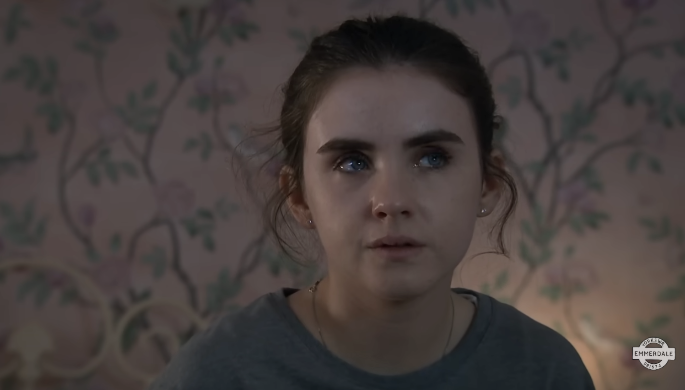 April scared in her room in Emmerdale