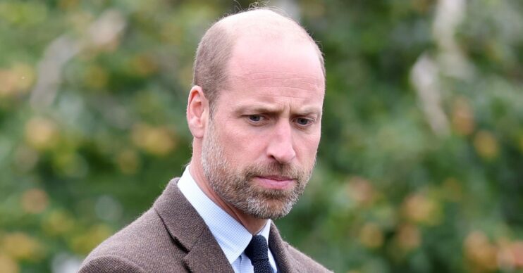 Prince William looking down and frowning