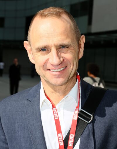 Evan Davis in suit smiling