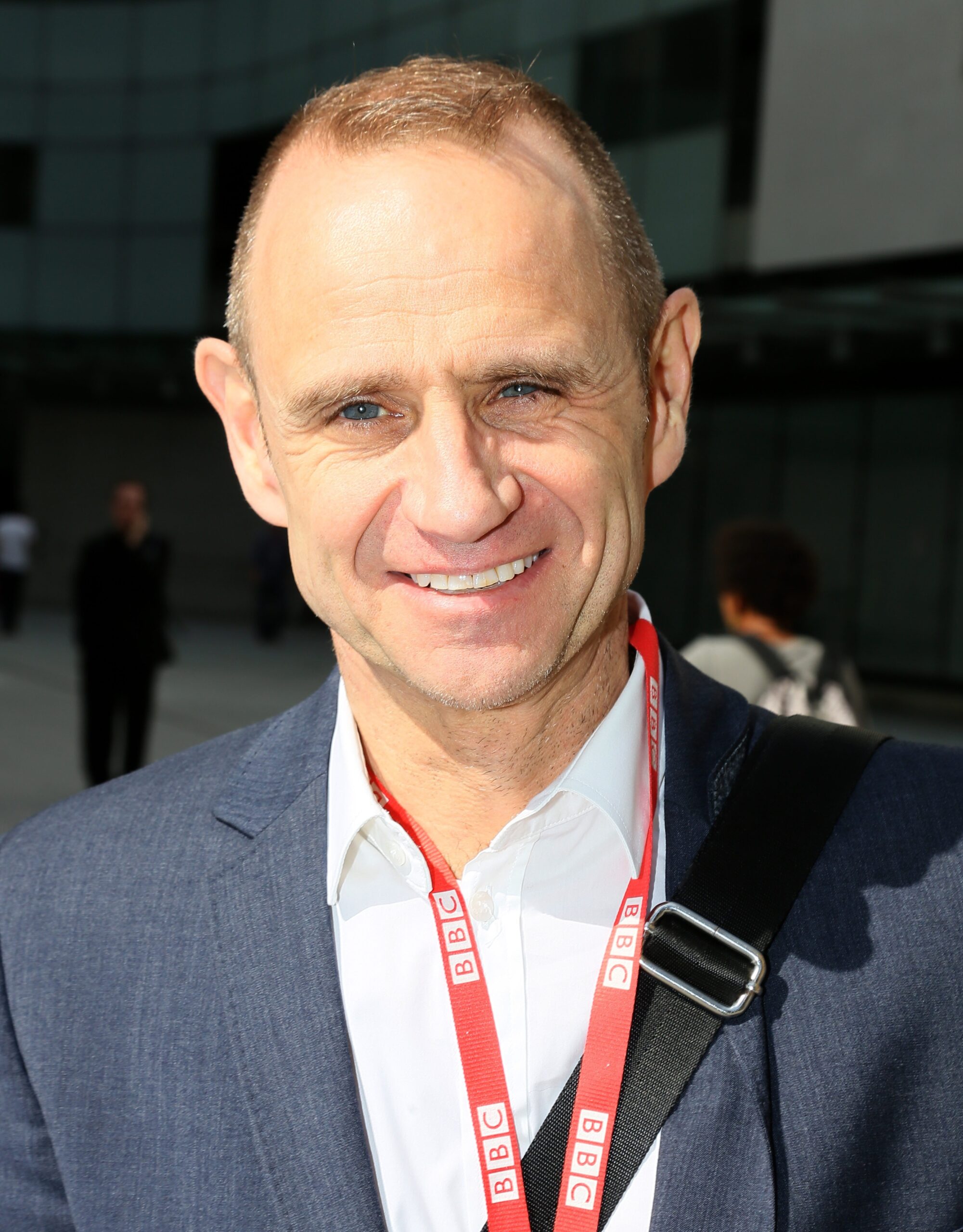 Evan Davis in suit smiling