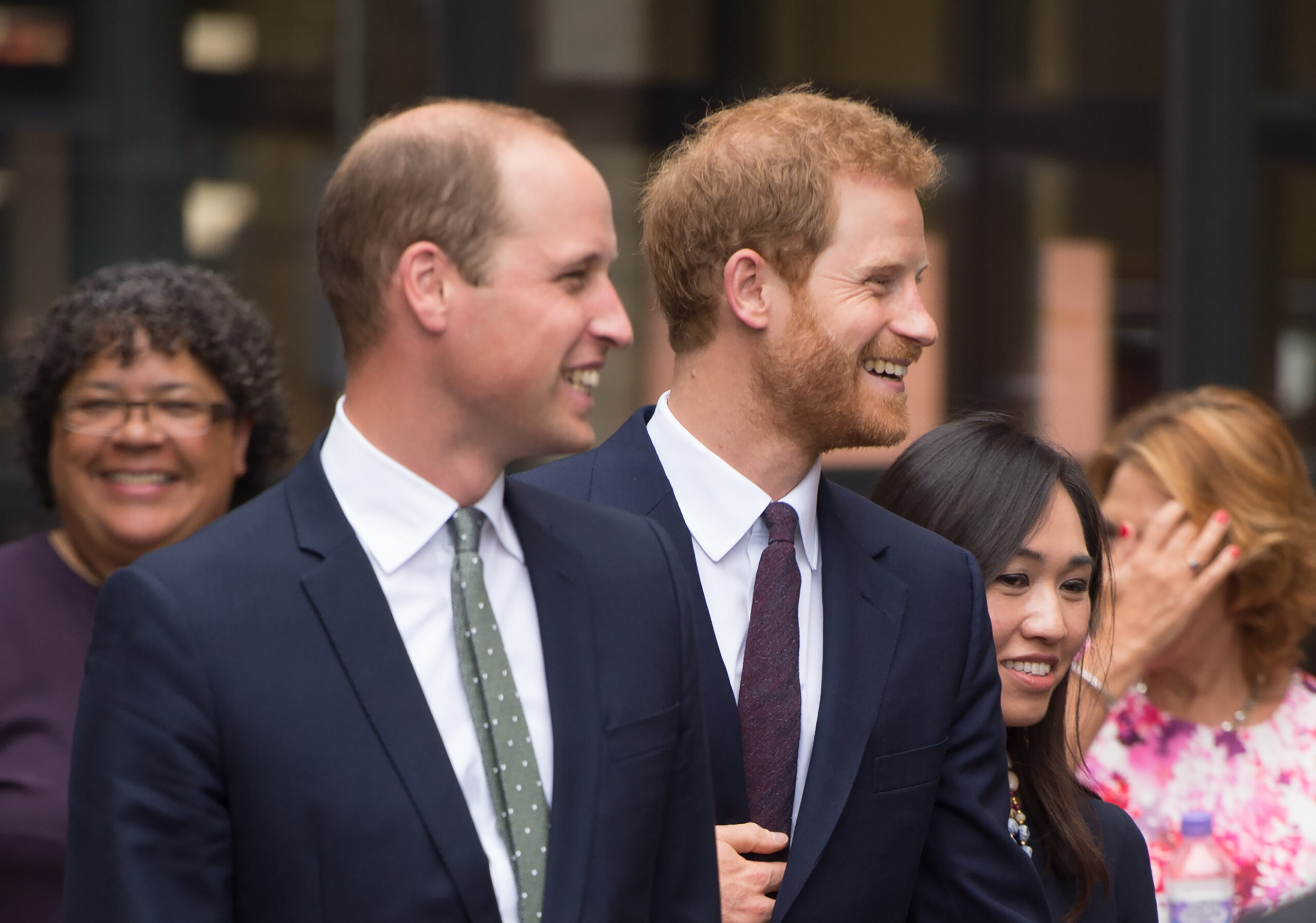 Prince William and Harry smiling during royal engagement