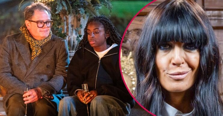 Alan Carr and Cat Burns sitting in front of a fire in The Celebrity Traitords