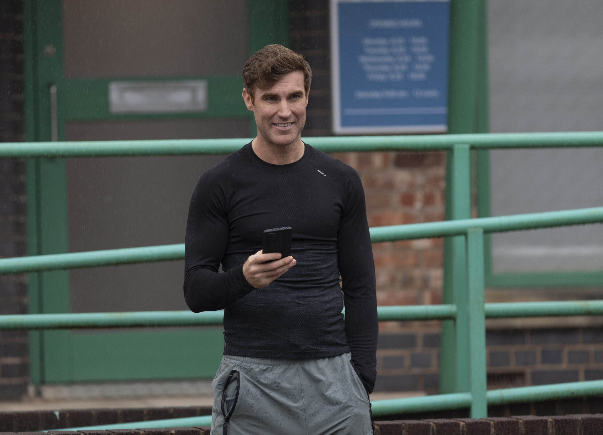 Theo smiling on phone in Coronation Street