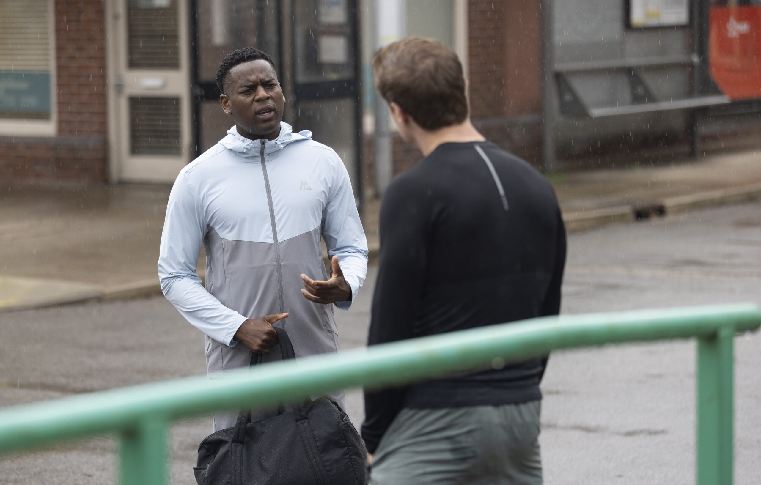 James and Theo talking outside in Corrie
