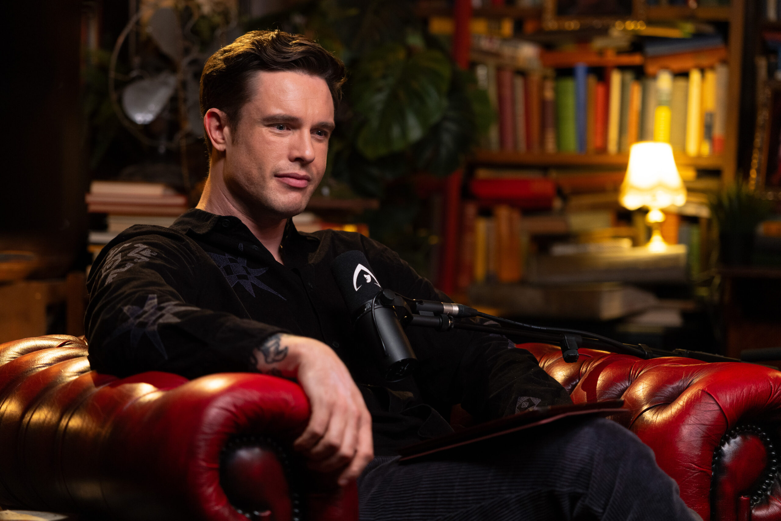 Ed Gamble sits in a red leather chair