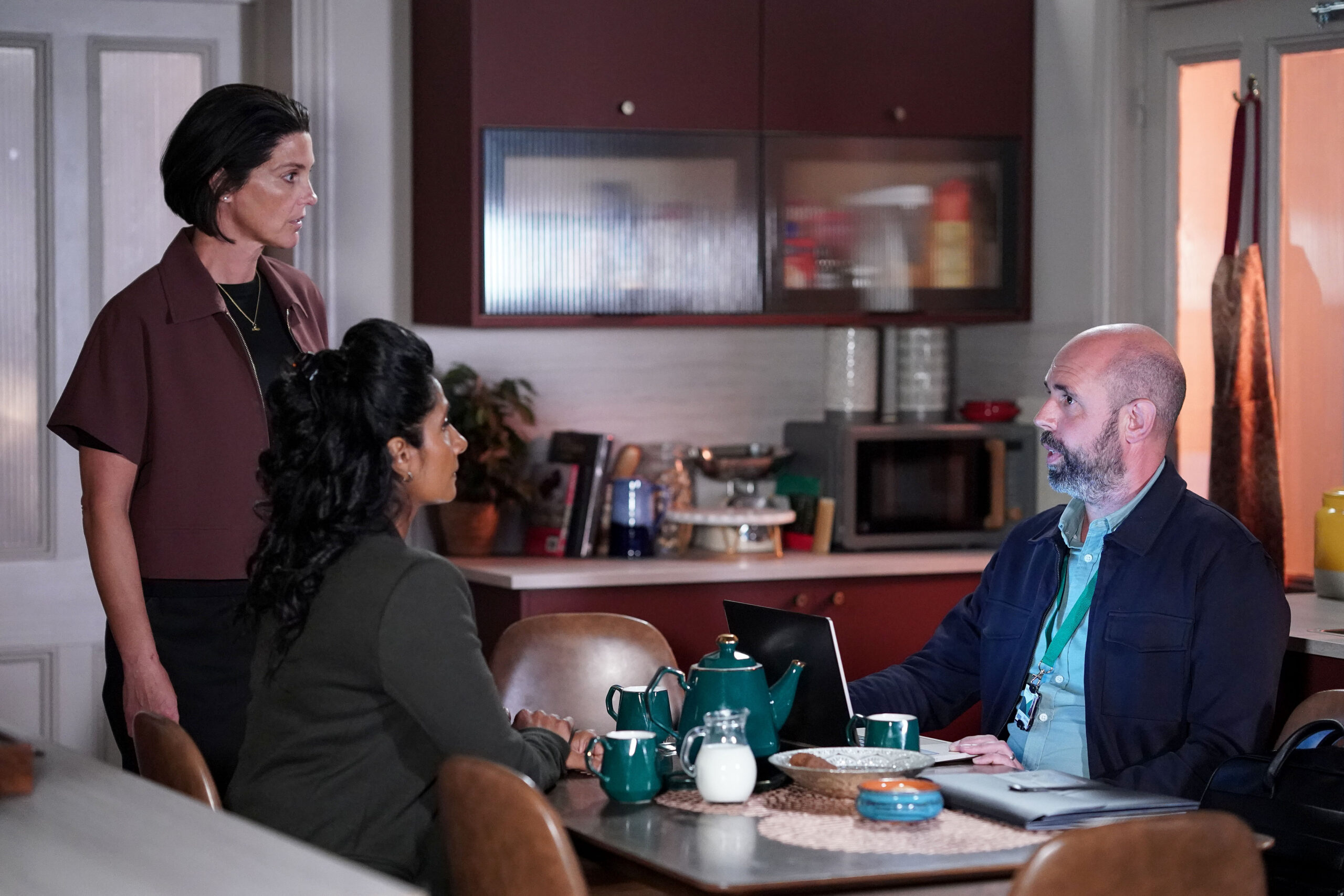 Suki and Eve talk to their case worker, Robin