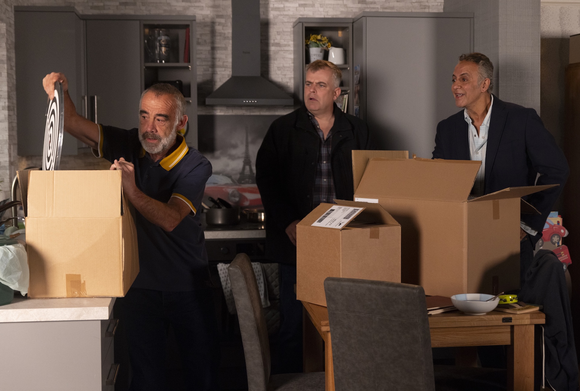 Kevin showing darts board to Steve and Dev