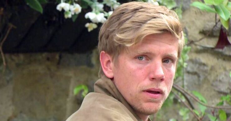 Robert looks worried in Emmerdale (Credit: BBC/Composite: ED!)