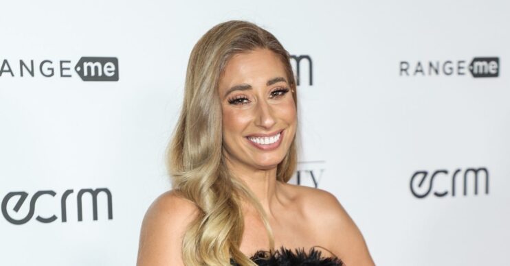 Stacey Solomon poses on the red carpet in a black dress