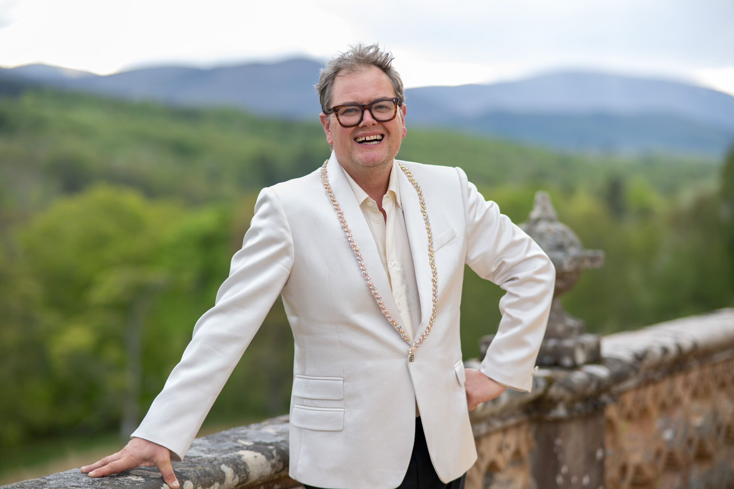 Alan Carr in a white jacket on the set of The Celebrity Traitors