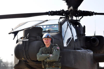 Prince Harry stood in front of a Apache Helicopter, taken while he was in the French Alps on his Mountain Flying training in March 2011