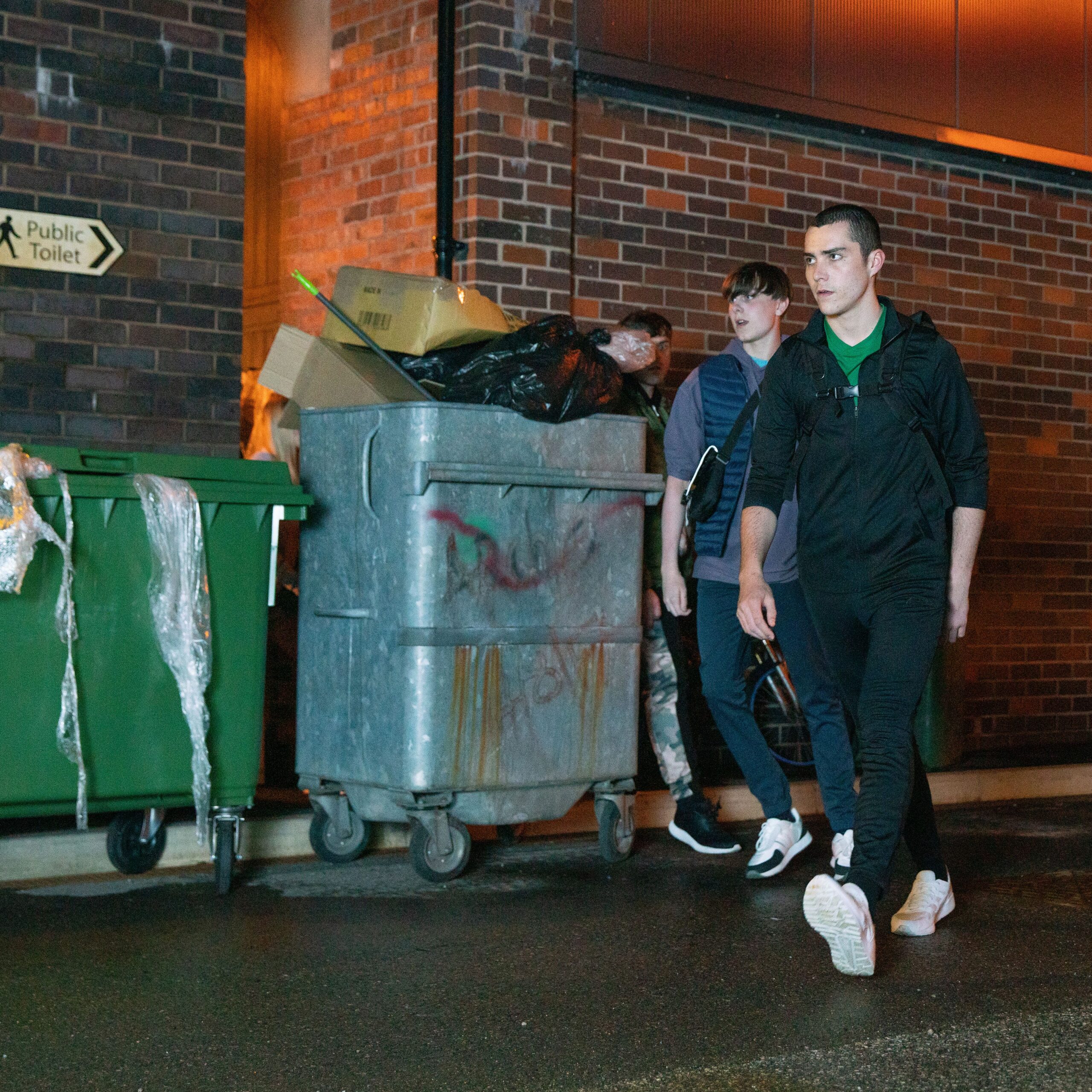Coronation Street's Eli and Corey by bins