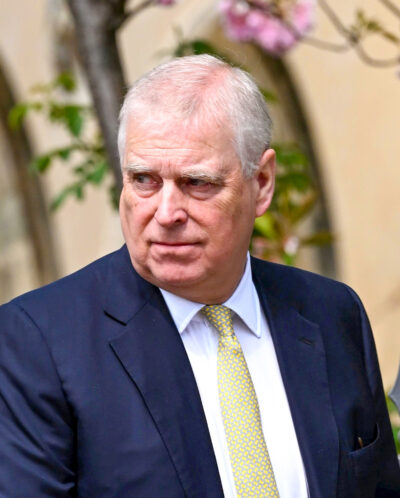 Andrew walking outside in suit and tie