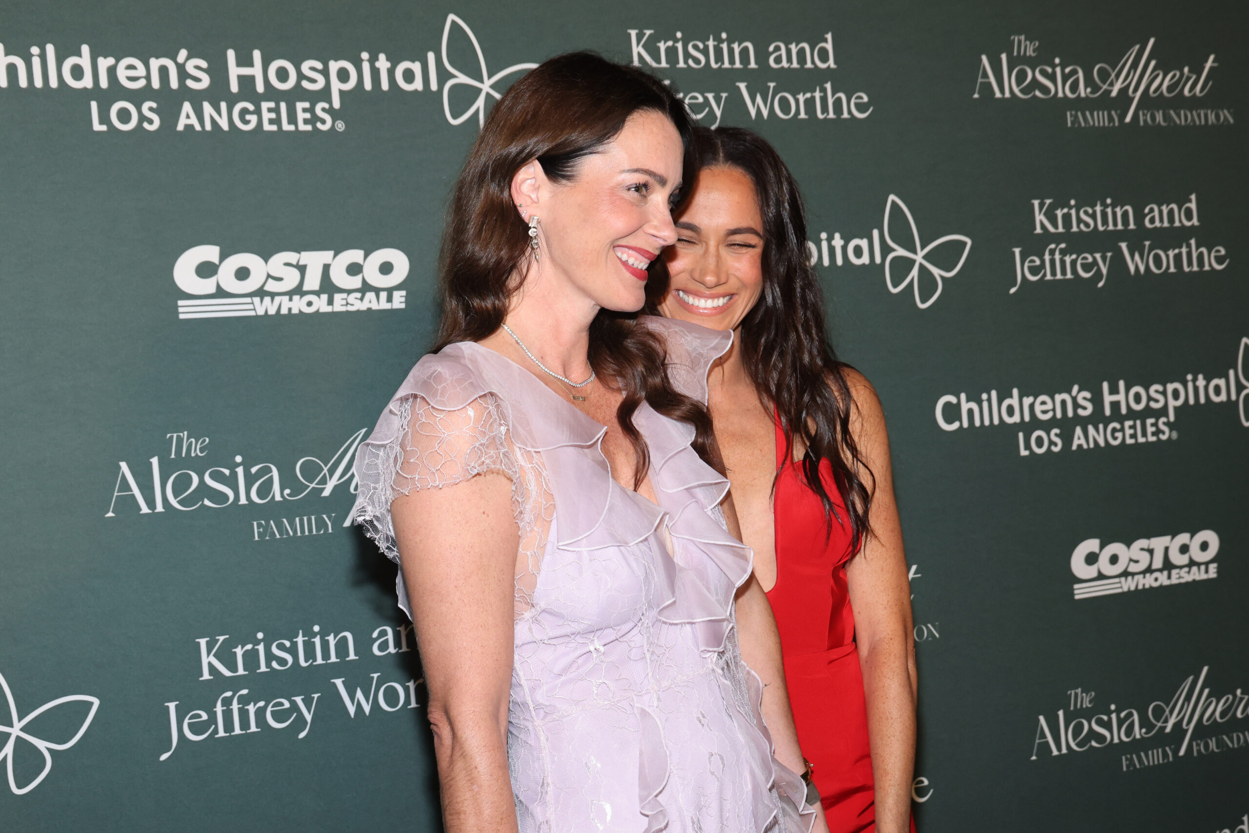 Kelly McKee Zajfen and Meghan Markle smiling at event