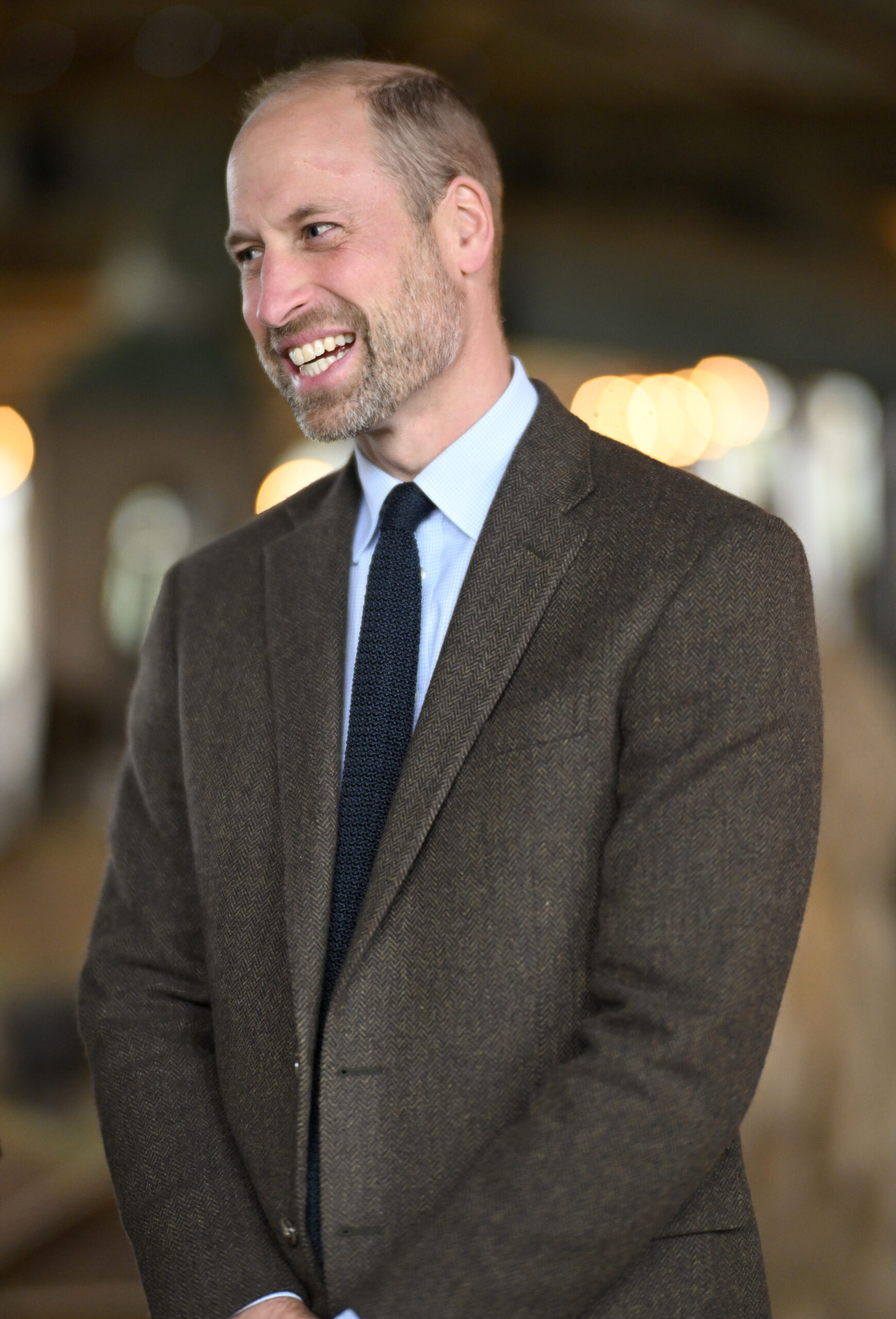 Prince William smiling and laughing in suit