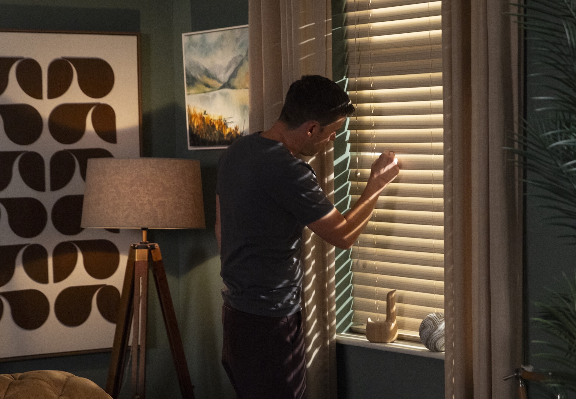 Coronation Street's Todd looking out of flat blinds