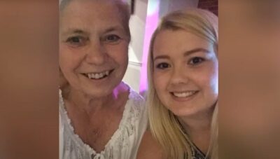 Helen Holland smiling beside her granddaughter