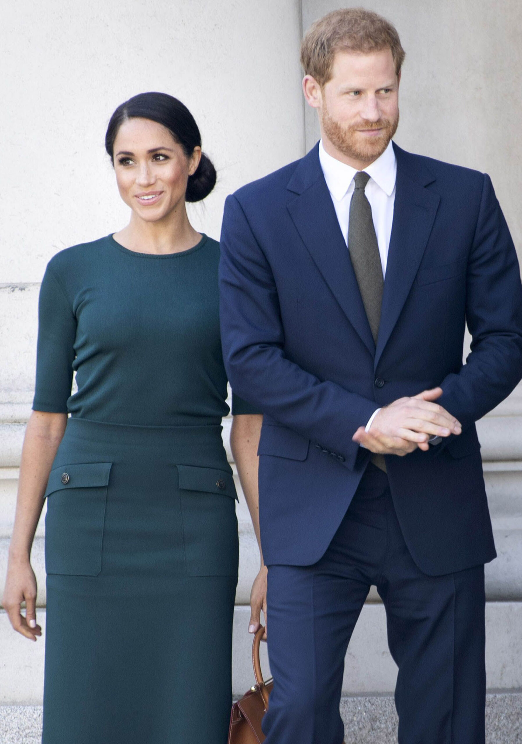 Meghan Markle and Prince Harry smiling side by side