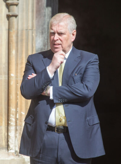 Andrew Mountbatten-Windsor standing in suit with hand on chin