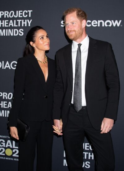 Meghan and Harry at an event holding hands