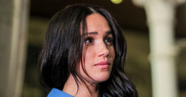 Meghan Markle looking worried in blue