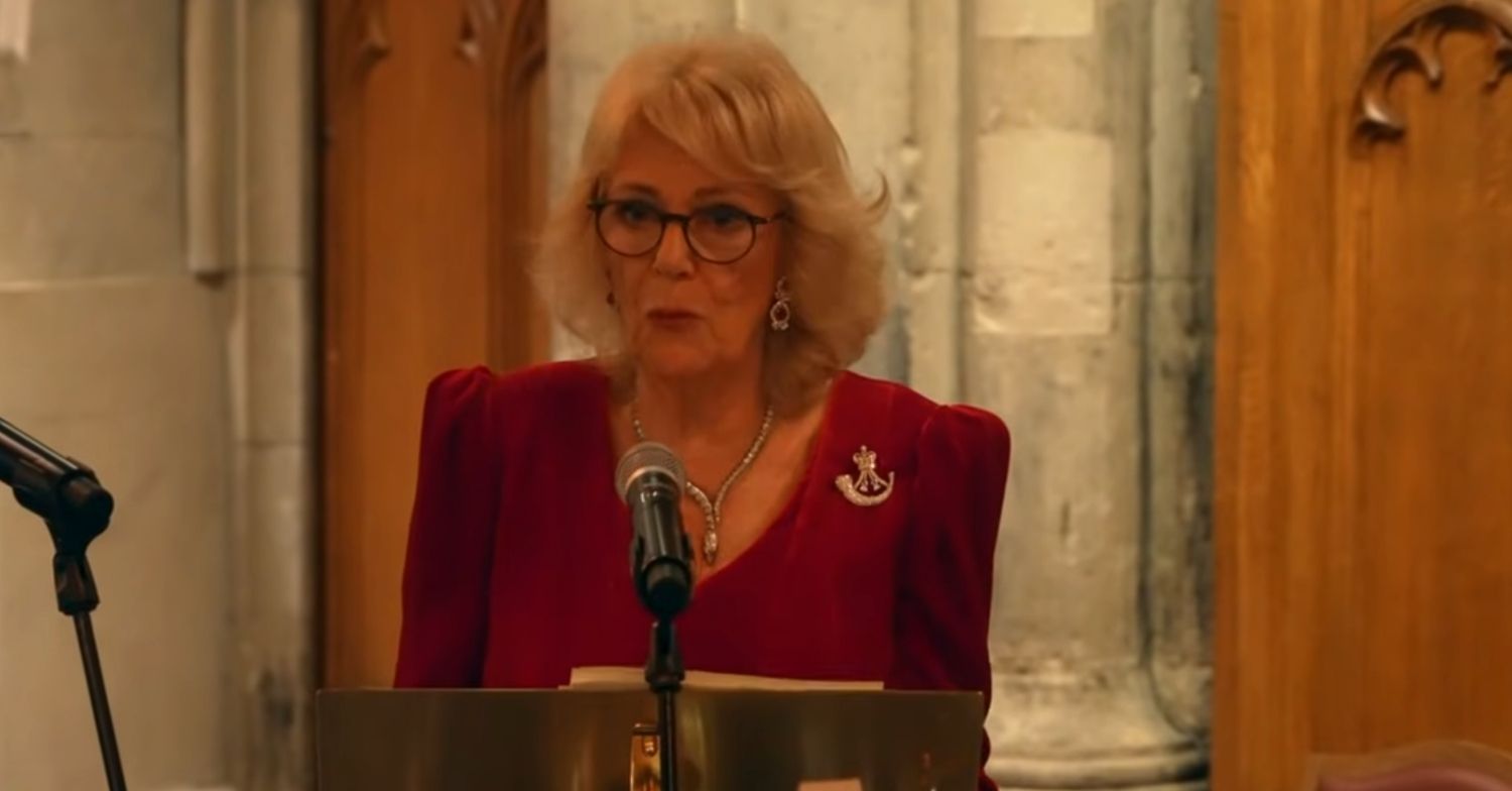 Queen Camilla giving a speech in a red dress