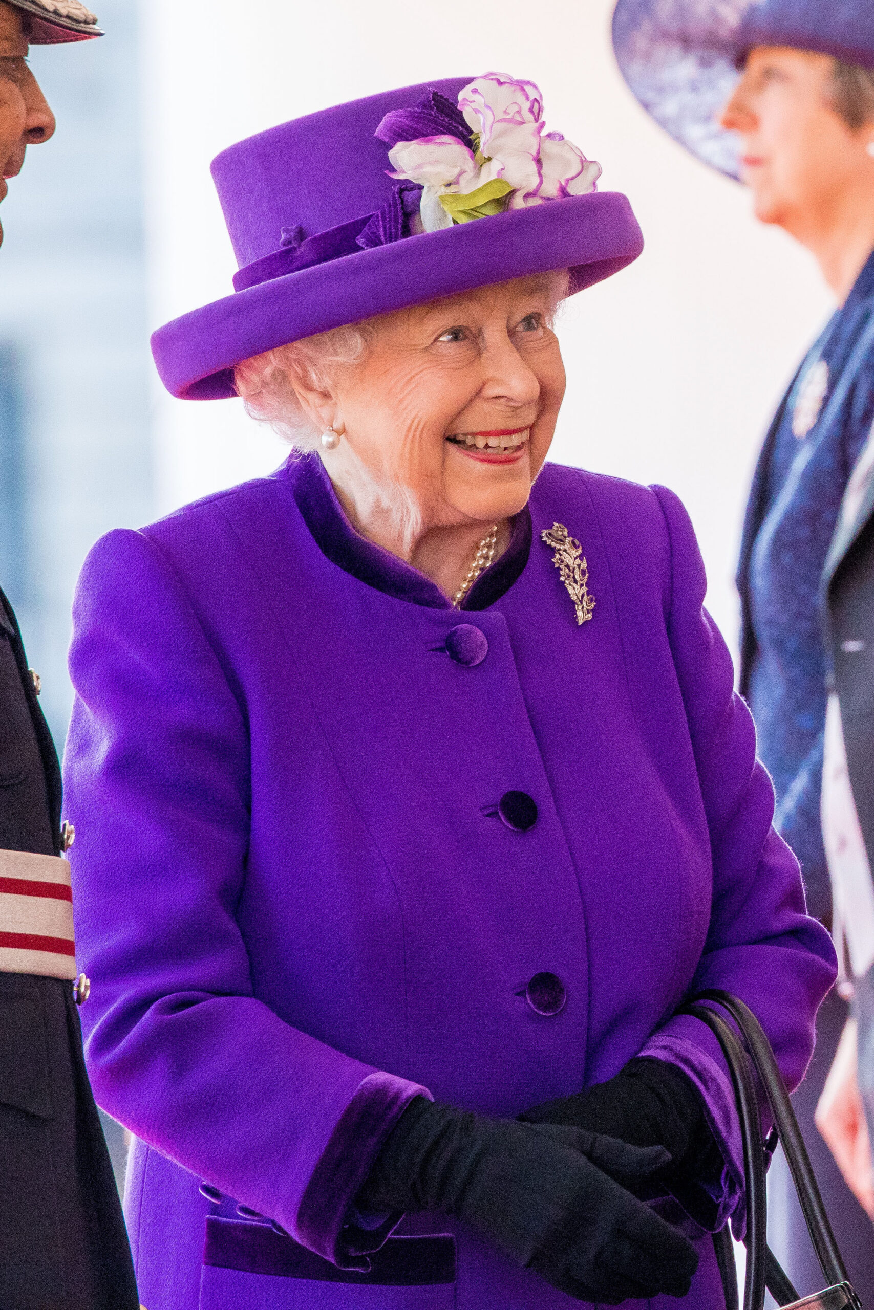 Queen Elizabeth II smiling in purple