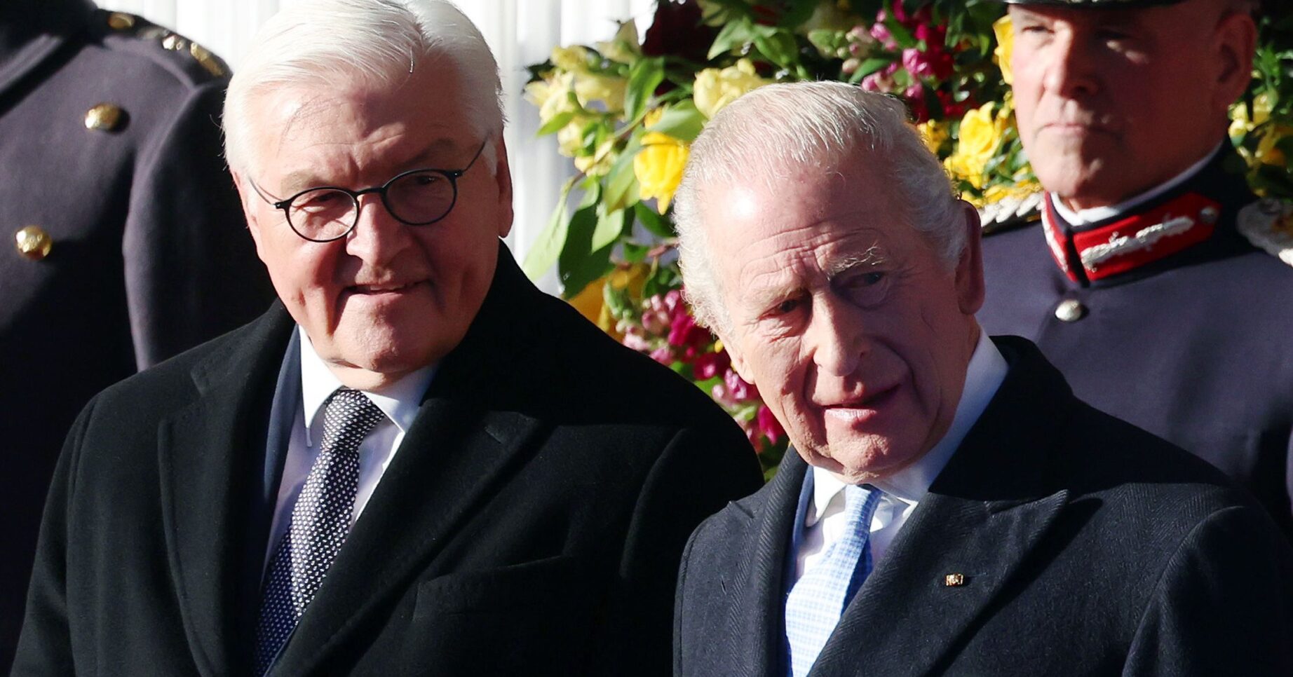 King Charles frowning beside President Frank-Walter Steinmeier