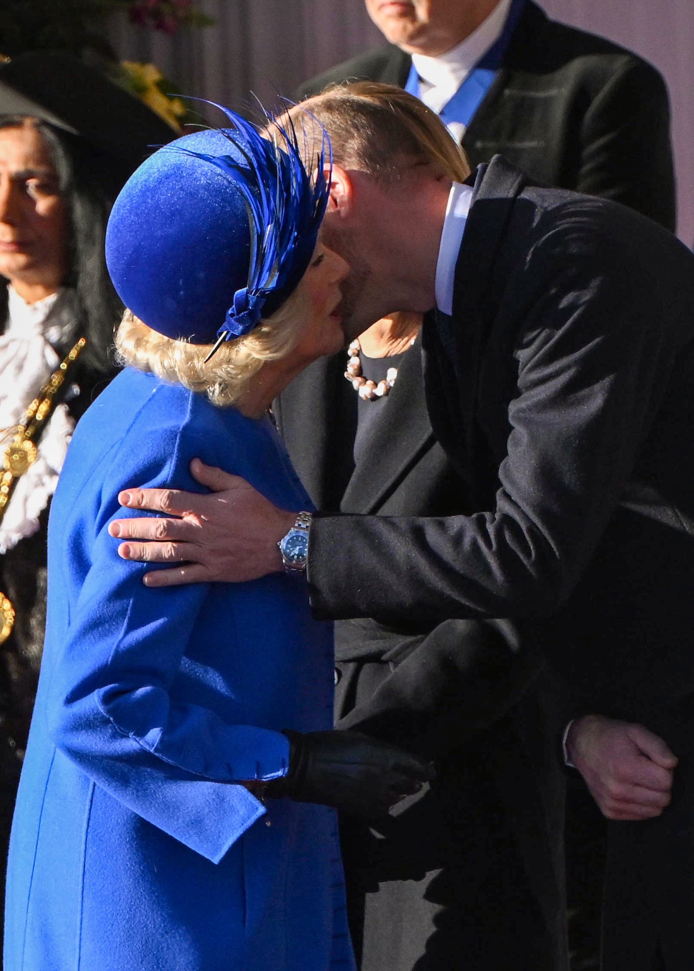 Queen Camilla giving William a kiss on cheek