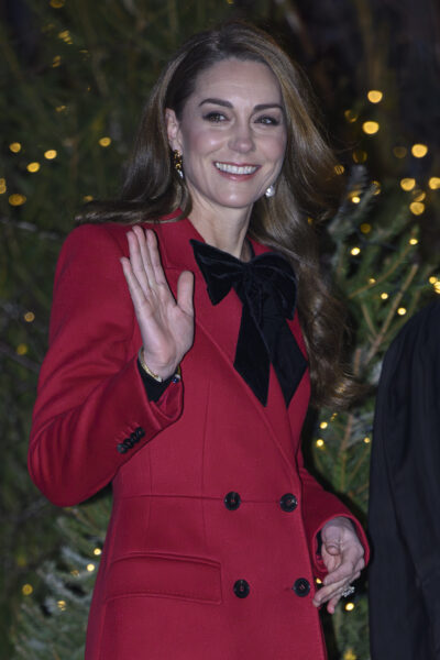Kate Middleton smiling in red coat for Christmas carol service