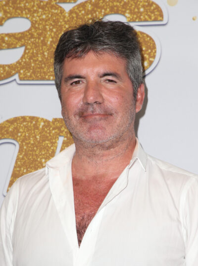 Simon Cowell wearing a white shirt looking fuller in the face