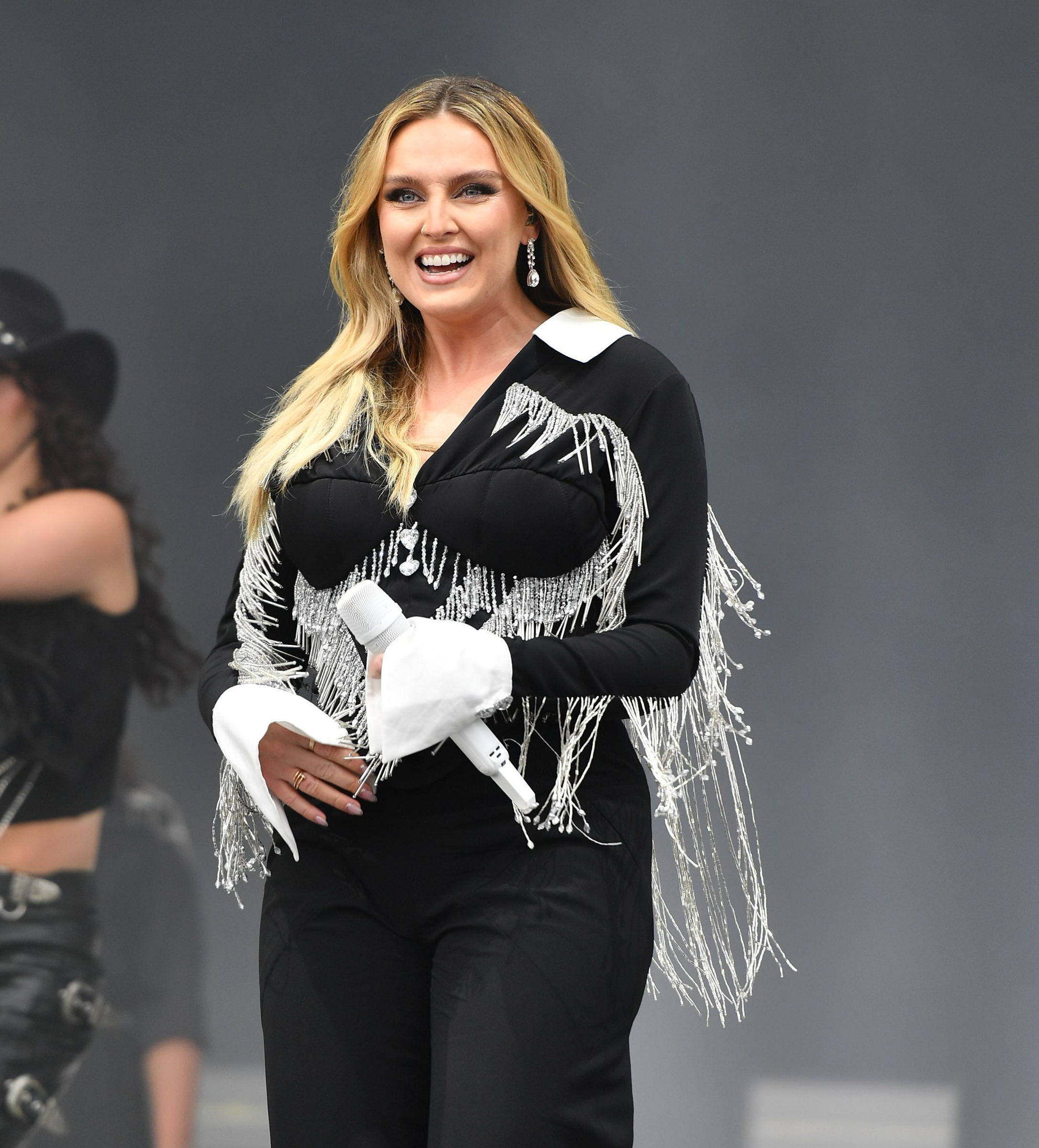 Perrie Edwards on stage performing