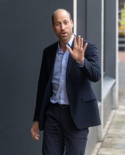 Prince William walking in suit and waving