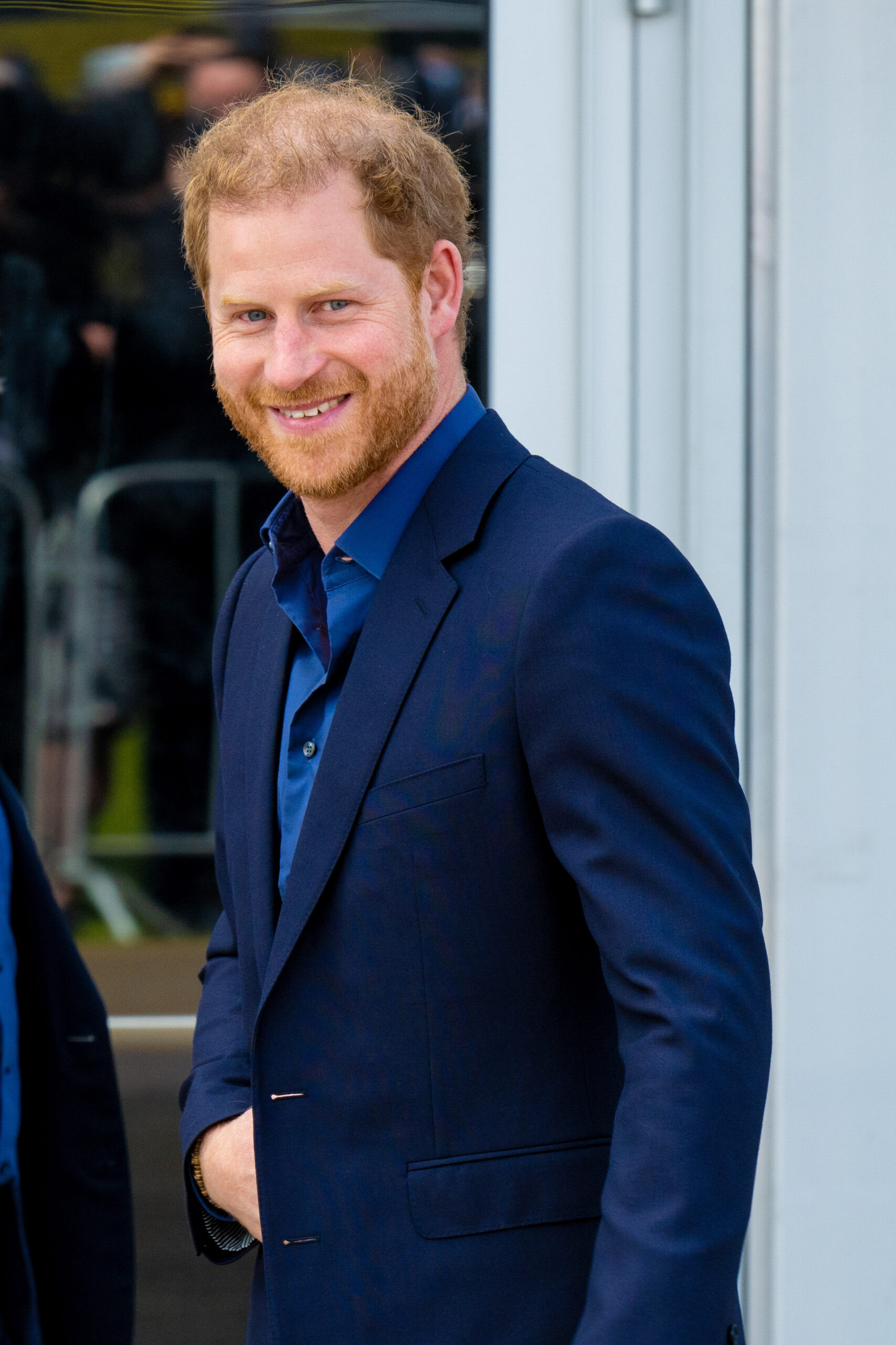 Prince Harry smiling in blue outfit