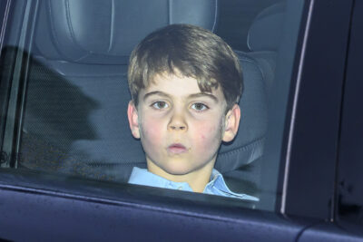 Prince Louis pouting from inside car