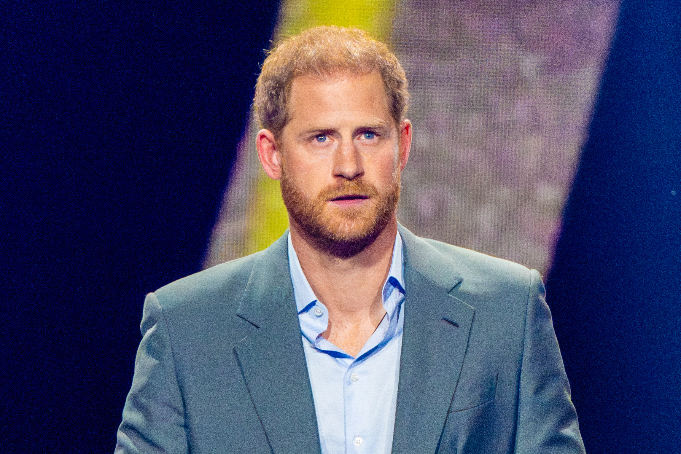 Prince Harry looks serious on stage